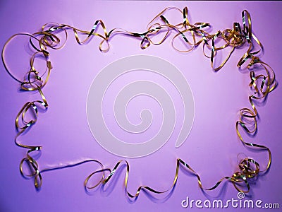 Wavy golden ribbon frame on lilac background, copy space for new year, christmas Stock Photo