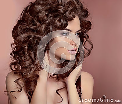 Wavy hair. Beautiful girl with makeup. Curly hairstyle. Brunette Stock Photo