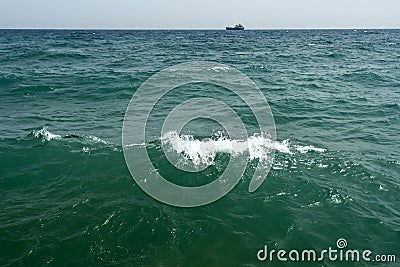 Wavy sea water surface and ship on the horizon Stock Photo