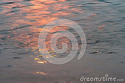 Wavy water surface with glittering orange sun light. 6 Stock Photo