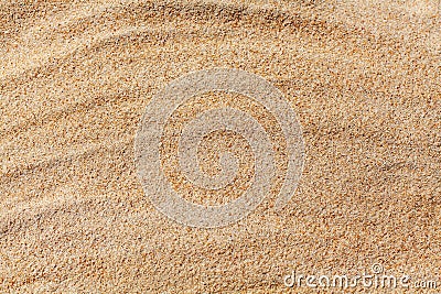 Wavy yellow sand texture background, sandy waves pattern, sand grains, rippled dry sand surface top view, desert dune Stock Photo