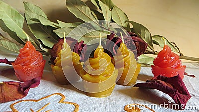 Wax candles of cake shape in different colors with some decorations Stock Photo