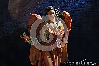 wax Christmas figurine of Gloria Angel on a dark background Stock Photo