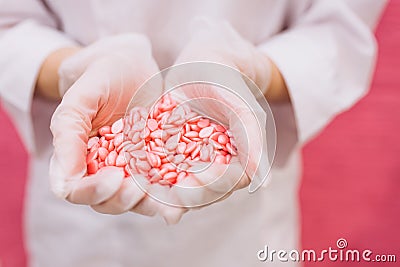 Wax for depilation of pink color in the form of a heart. The concept of depilation, waxing, smooth skin. Copy space Stock Photo