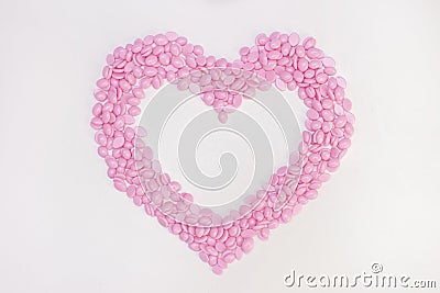 Wax for depilation of pink color. in the form of a heart. On white background. The concept of waxing, Stock Photo