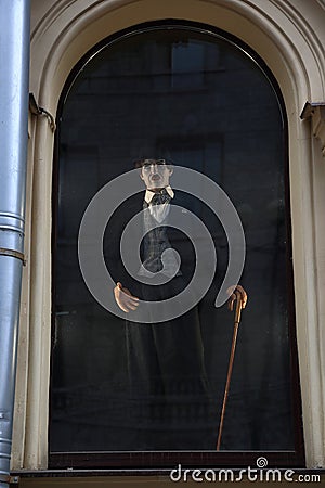 Wax figure of Charlie Chaplin in the window, view from the street Editorial Stock Photo