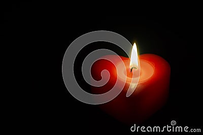 Wax red heart in the dark Stock Photo