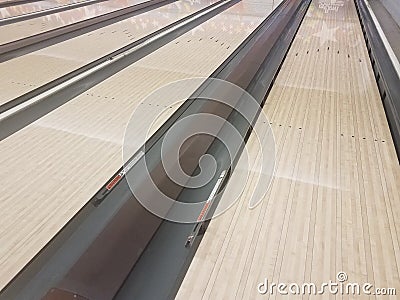 Waxed wooden bowling alley lanes with bumpers Stock Photo
