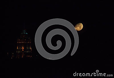 Full moon in the city. Waxing crescent and building. Night town Stock Photo