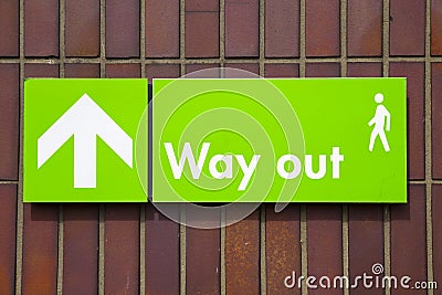 Way out sign with green background and white writing Stock Photo