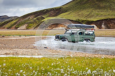 4WD car wades river in Landmannalaugar in Iceland Stock Photo