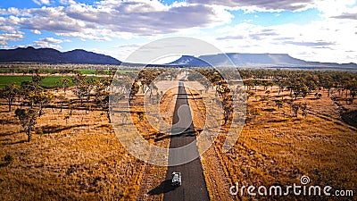 4wd Road Trip jeep journey to Ayers Rock through the rural Outback Australia valleys in desert land with mountains in the backgrou Stock Photo