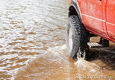 A 4wd truck on flooded road Stock Photo