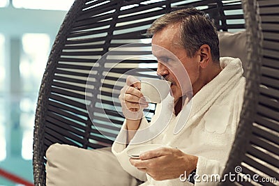 Wealthy Senior Man Enjoying Coffee in SPA Resort Stock Photo