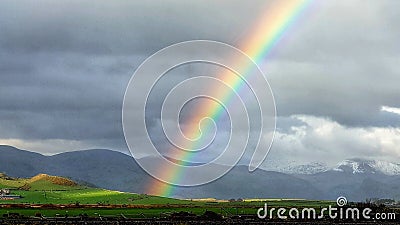 Weather creating a bright rainbow Wales Stock Photo