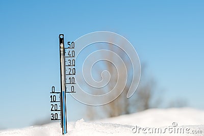 Weather forecast. Thermometer on snow show low temperature. Blue sky. Meteorology Stock Photo