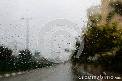 Weather in Israel: Winter rains. Abstract view to rainy road city through the car windscreen Stock Photo