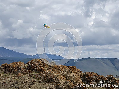 Weather vane, wind designator against the blue mountains Stock Photo