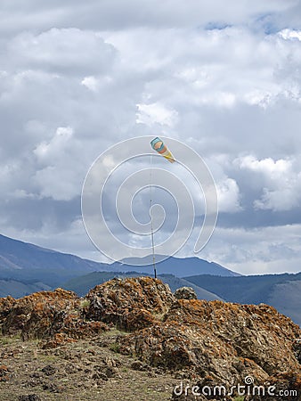 Weather vane, wind designator against the blue mountains Stock Photo