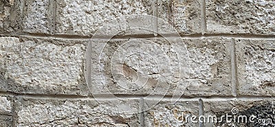 Weathered aged stone masonry of old house. Ancient brick wall background. Old uneven scratched stone bricks texture. Turkish Stock Photo