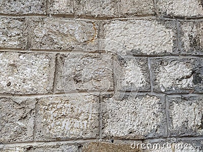 Weathered aged stone masonry of old house. Ancient brick wall background. Old uneven scratched stone bricks texture. Turkish Stock Photo