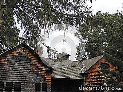 Weathered cedar shake historic house with cupola Lorenzo Stock Photo