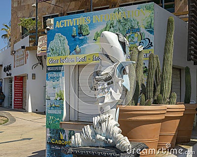 Weathered cool shark statue and large pots with cacti along the dock in Cabo San Lucas. Editorial Stock Photo