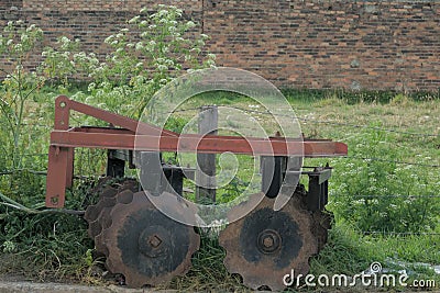 Rusty Relic: Farm Implement in a Field Stock Photo