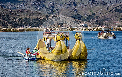 Weathered reed boats along the coast of Lake Titicaca in Puno, P Editorial Stock Photo