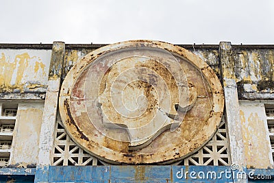 Weathered rusty house facade with woman head relief Editorial Stock Photo