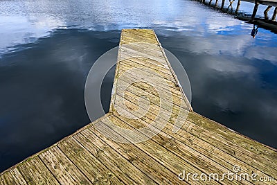 Weathered wooden dock in Luther Burbank Park on Mercer Island, WA, and a peaceful day on Lake Washington Stock Photo