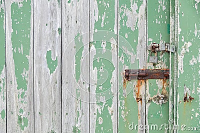 Weathered wooden door peeling green paint Stock Photo