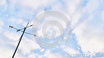 Weathervane under the culumus sky. Stock Photo