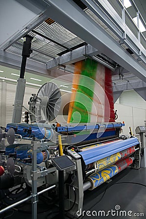 Weaving automatic machines - Weaving is a method of textile production in which two distinct sets of yarns or threads are Stock Photo