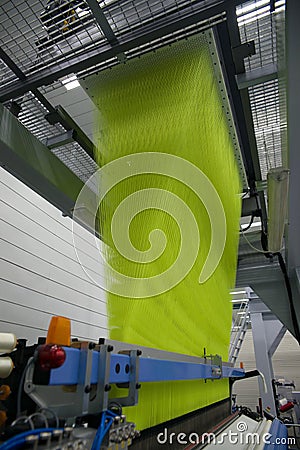 Weaving automatic machines - Weaving is a method of textile production in which two distinct sets of yarns or threads are Stock Photo