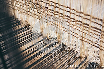 Weaving threads inside the loom Stock Photo