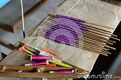 Weaving threads spun onto bobbins Stock Photo