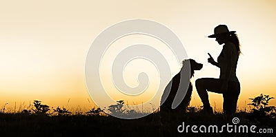 Dog and his trainer - silhouette image with blank, copy space Stock Photo