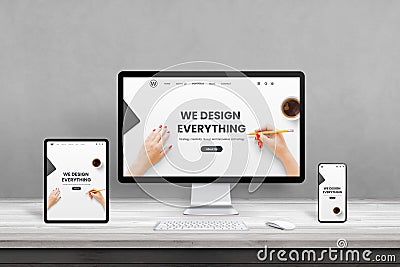 Web design studio with multiple devices on office desk. Concept of responsive, flat web page design Stock Photo