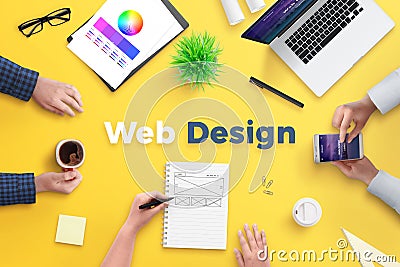 Web design team work on project concept. Yellow desk with web design text Stock Photo