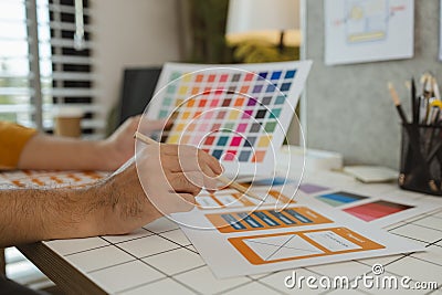 A web designer is using his idea to create a digital product design project that will meet the needs of users in terms of both Stock Photo