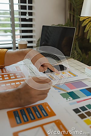 A web designer is using his idea to create a digital product design project that will meet the needs of users in terms of both Stock Photo
