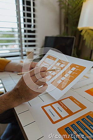 A web developer, as a User Experience and User Interface Officer, is designing beautiful and easy-to-use digital products that Stock Photo