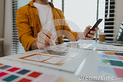 A web developer, as a User Experience and User Interface Officer, is designing beautiful and easy-to-use digital products that Stock Photo