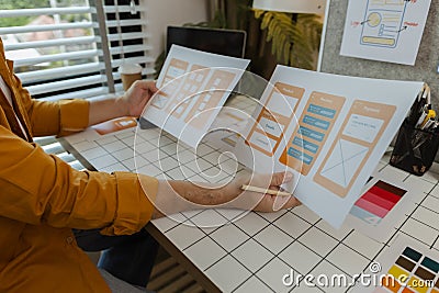 A web developer, as a User Experience and User Interface Officer, is designing beautiful and easy-to-use digital products that Stock Photo