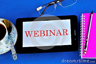 Webinar â€” web conference, online meetings or presentations over the Internet at the computer. A computer tablet, reading glasses Stock Photo