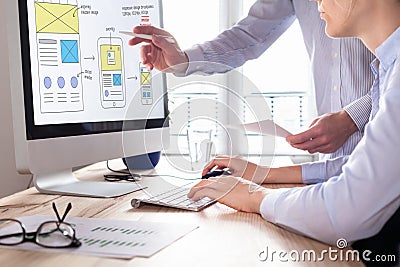 Website development team sketching wireframe layout for responsive web content Stock Photo