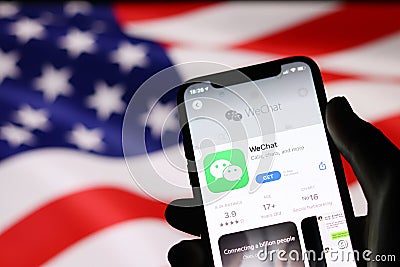 WeChat application on mobile phone screen on USA flag background Editorial Stock Photo