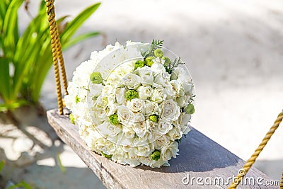 Wedding accessories. The bride's bouquet on a tropical beach. Stock Photo