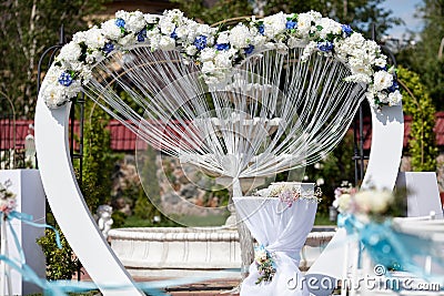 Wedding arch decorated with flowers outdoor Stock Photo